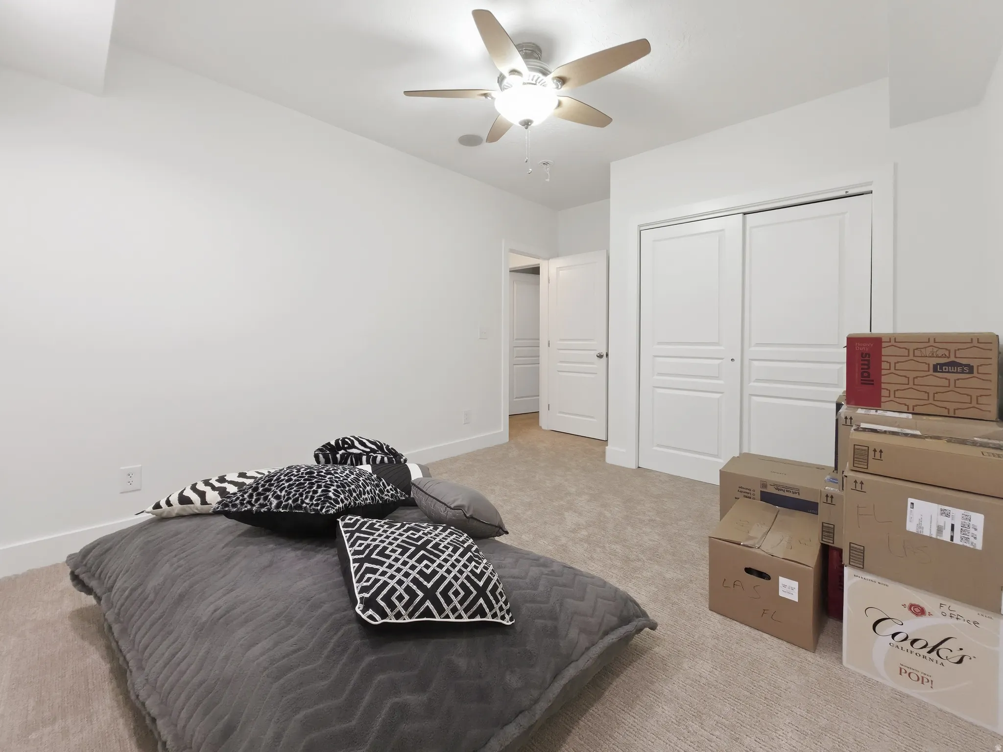 Recessed lighting, ceiling fan with integrated lighting, neutral carpet flooring, white painted walls, and white bi-fold closet doors