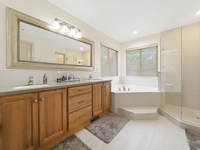 Dual vanity with wood-finish cabinetry and undermount sinks