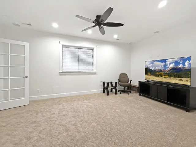 Recessed lighting, ceiling fan, white trim, and light-colored carpeting