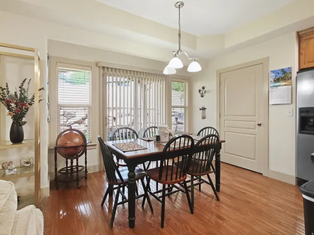 Hardwood flooring, tray ceiling, recessed lighting, white paneled door
