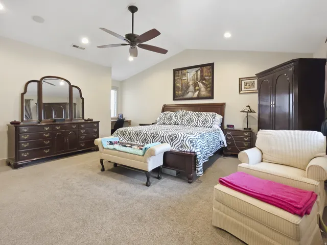 Vaulted ceilings with a ceiling fan, recessed lighting, and soft carpet flooring