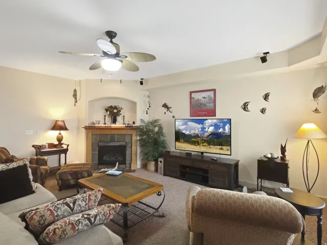 Recessed fireplace with stone surround and wood mantel