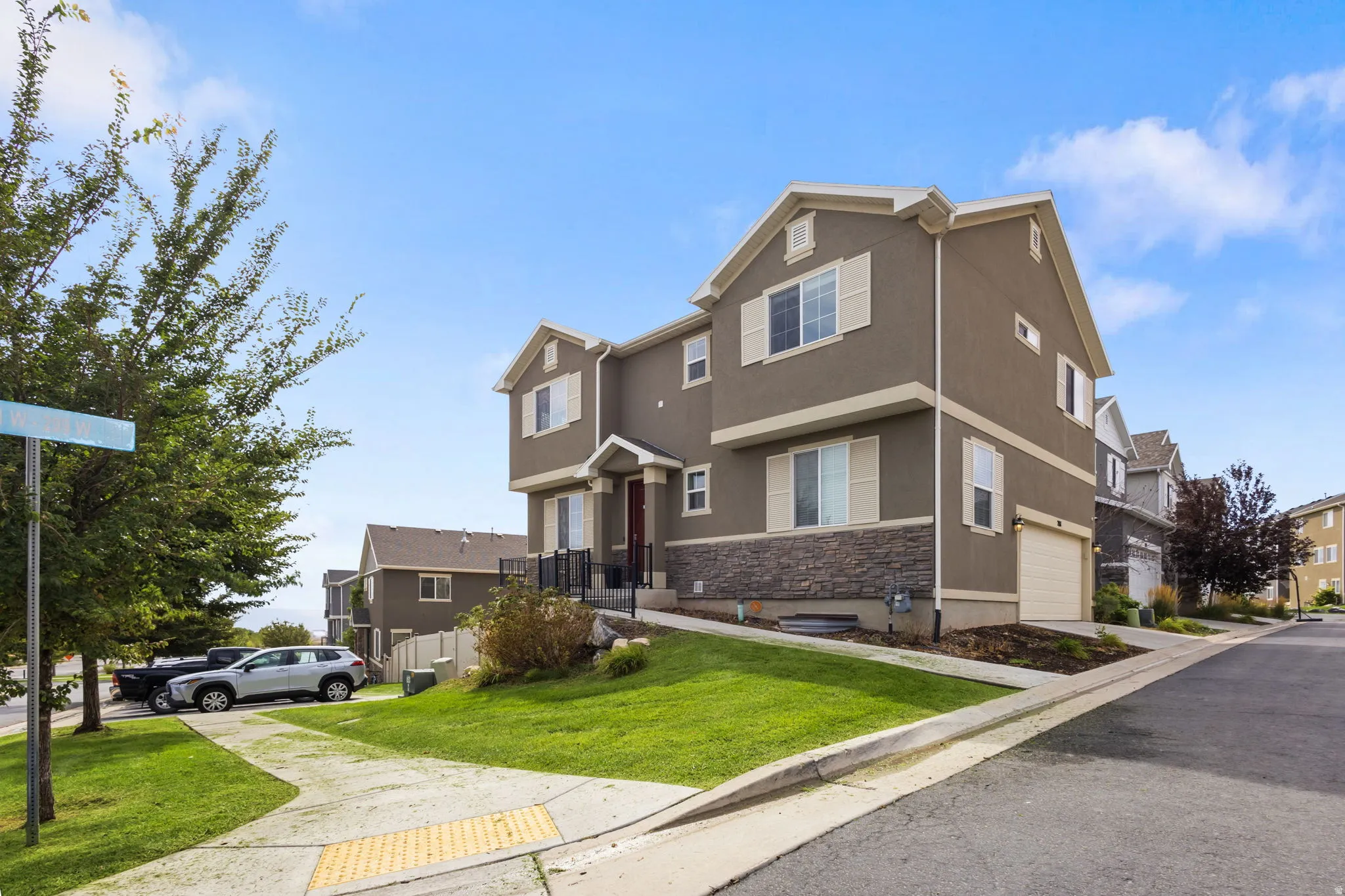 Contemporary multi-story exterior with stucco siding and stone accents