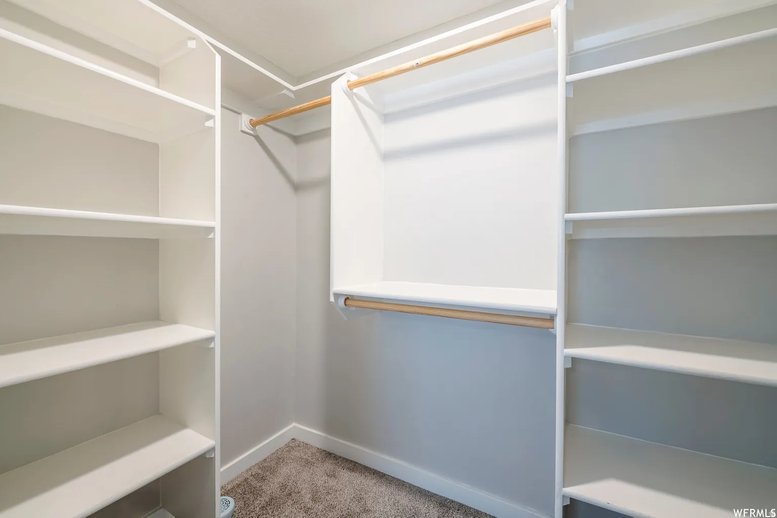 Built-in closet organization system featuring multiple shelves and hanging rods