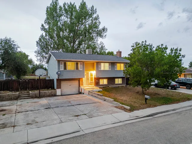 Two-story residence featuring light gray siding and brick accents
