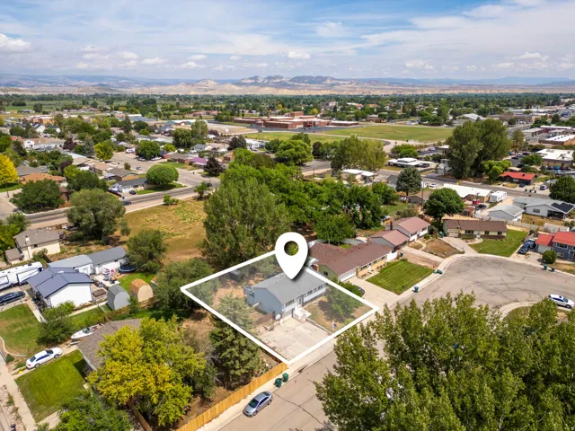 Aerial view showcasing this residential property situated on a generous lot with mature landscaping and established trees