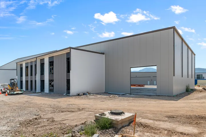 New construction commercial building featuring a modern design, large window expanses, and a spacious open bay