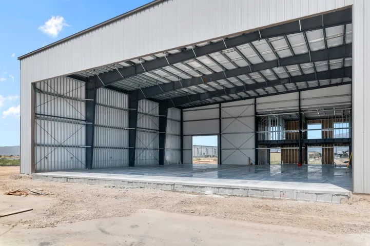 Large clear-span structure with a metal frame and corrugated metal siding