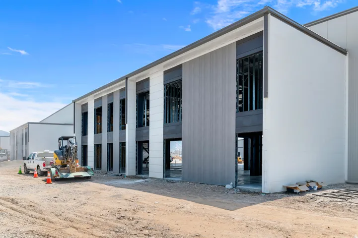 Modern building exterior with white and gray paneling and dark window framing