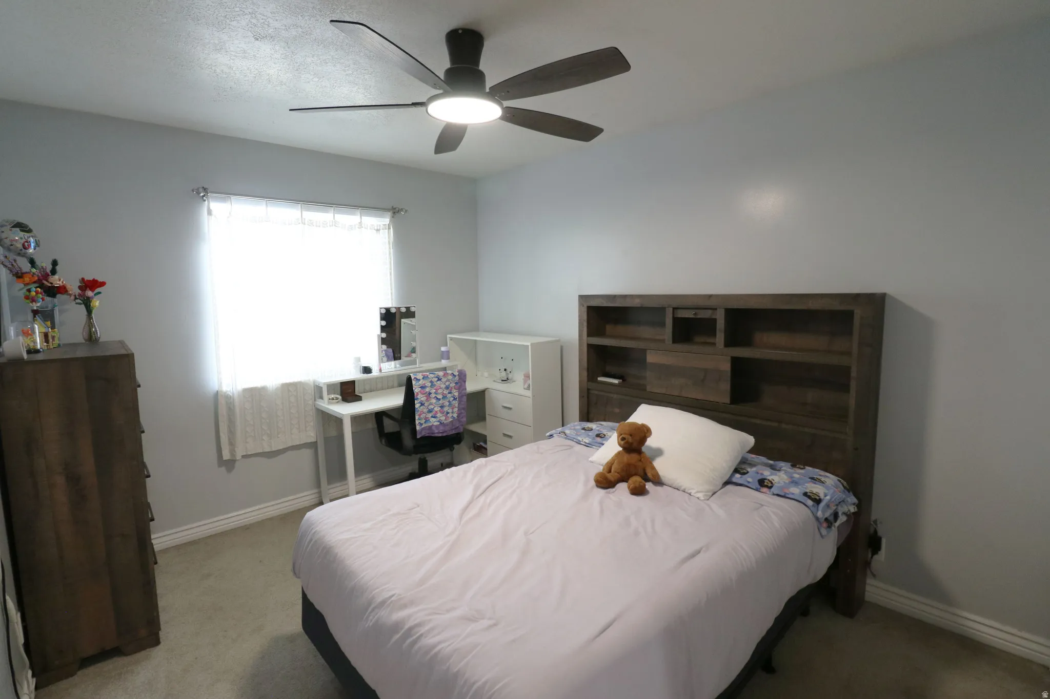 Light gray walls with a ceiling fan featuring integrated lighting
