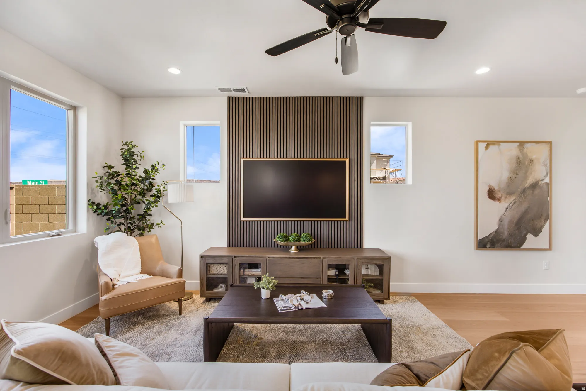 Recessed lighting and a ceiling fan illuminate the living area