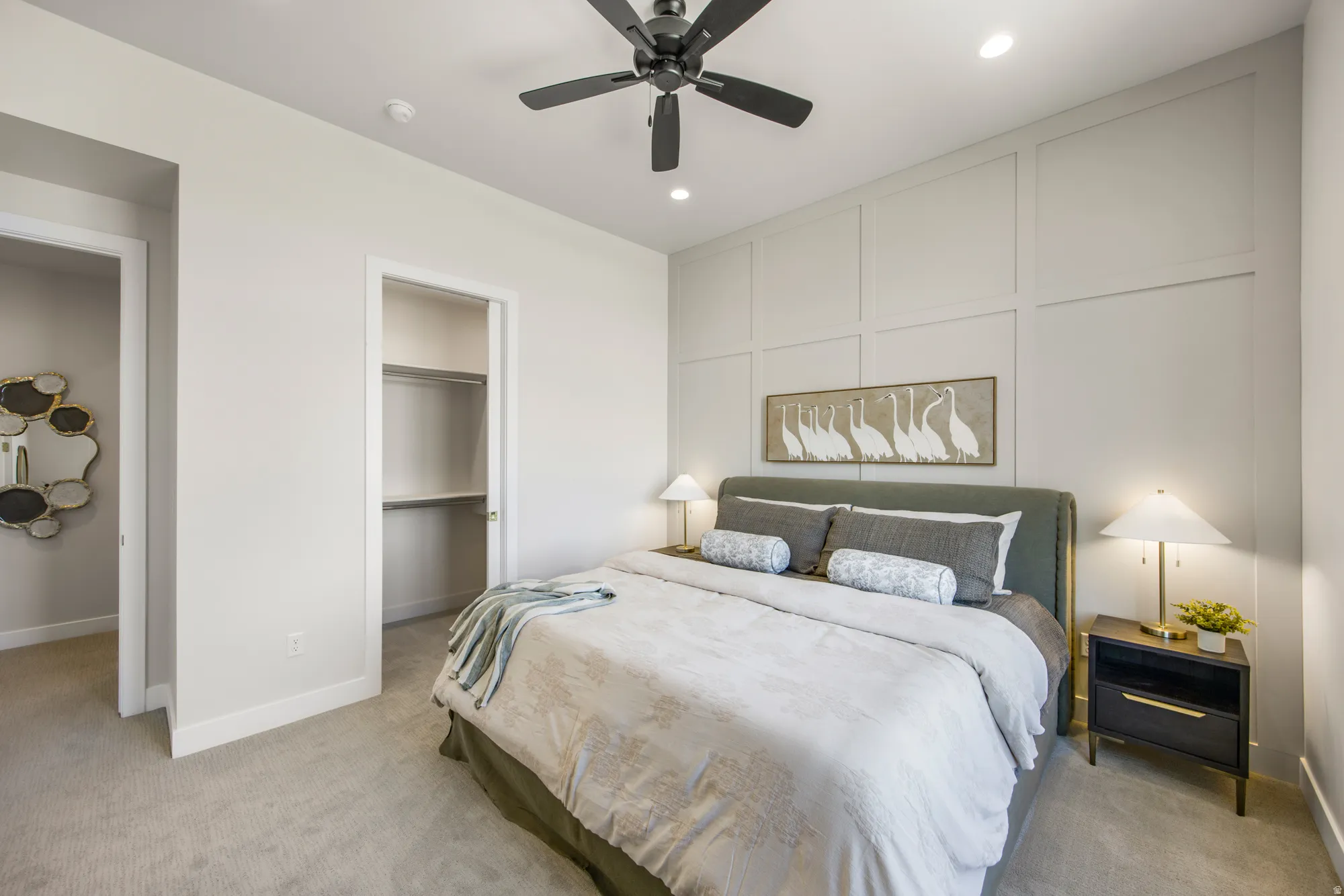 Carpeted flooring, recessed lighting, ceiling fan, board and batten wall accent, and a built-in closet with shelving