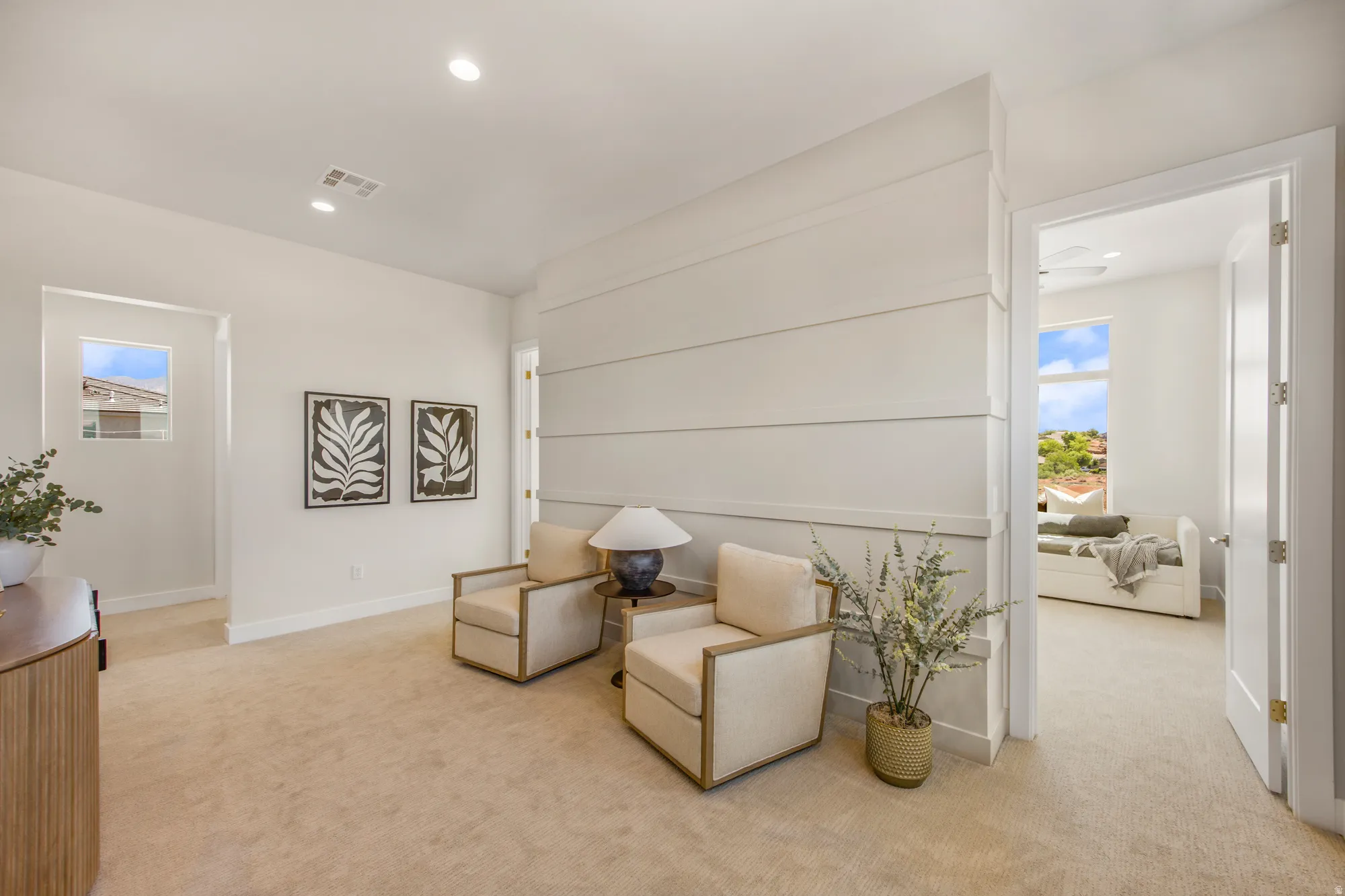 Neutral color palette with recessed lighting, shiplap accent wall, and light-colored carpeting