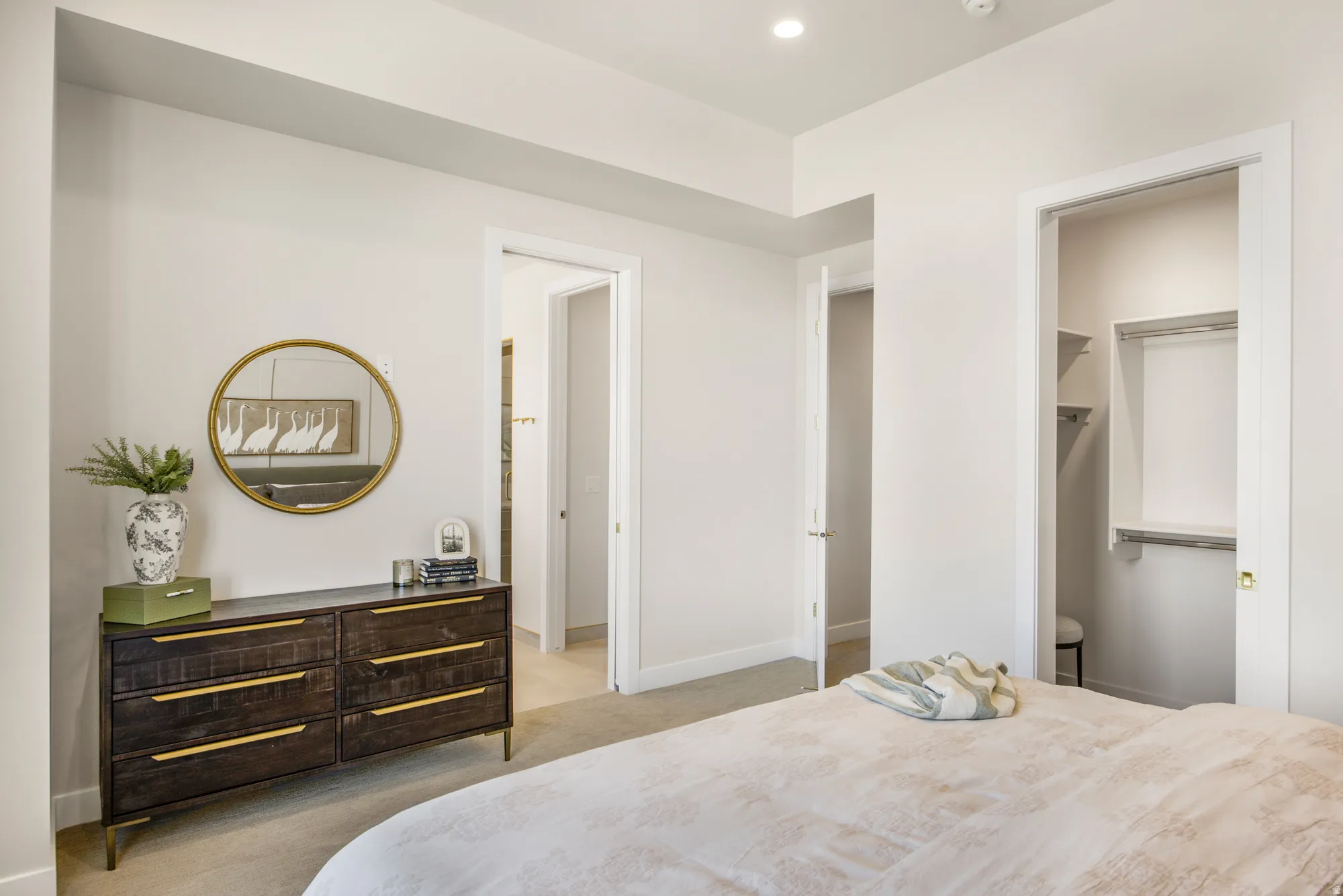 Recessed lighting, wall-to-wall carpeting, and a built-in closet with shelving
