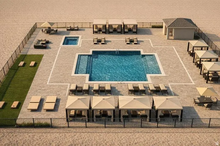 Expansive paver patio with a central swimming pool, integrated spa, and cabana structures