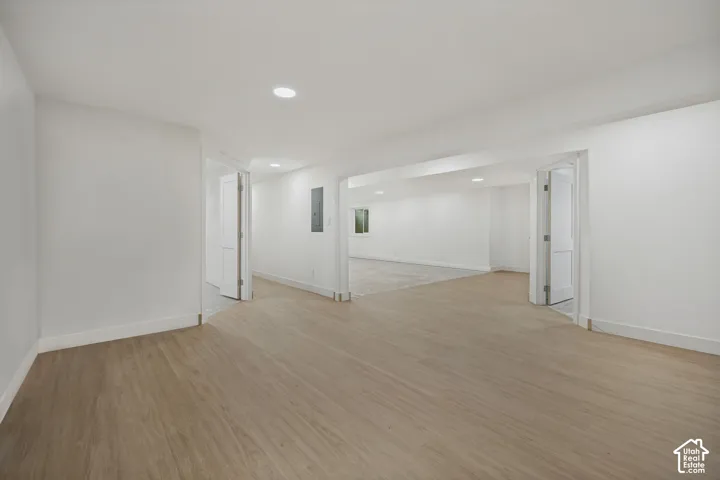 Expansive interior with wood-finish flooring, recessed lighting, and white trim