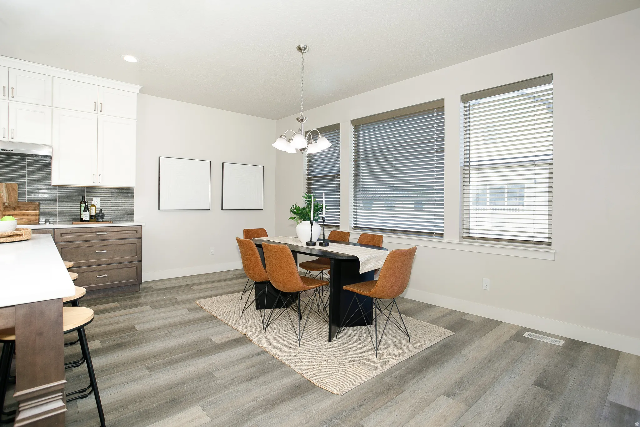 Wood-finish flooring throughout, complemented by a kitchen island with seating