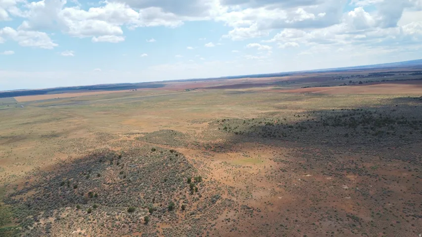 Expansive land offering diverse natural terrain and open fields under a wide sky
