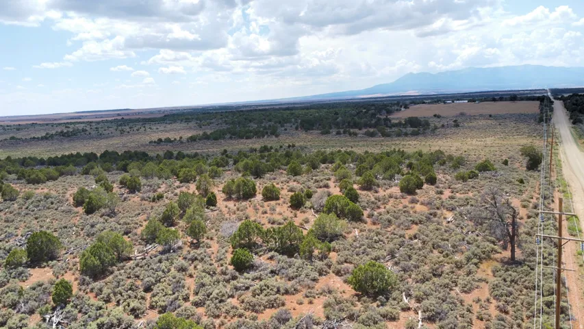 Additional contentThe image shows expansive acreage with sparse vegetation, desert scrubland, and distant mountain ranges, but lacks sufficient detail of the primary residence or definable property improvements to craft a compliant listing caption
