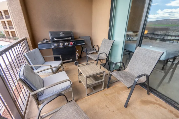 Private balcony with a sliding glass door, plaster wall finish, and metal railing