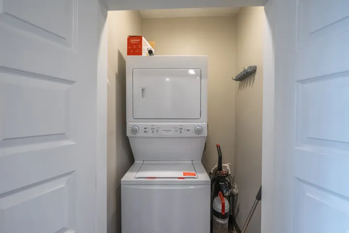 Stacked laundry appliances in a dedicated alcove