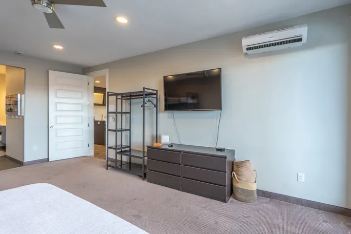 Wall-mounted air conditioning unit, ceiling fan, recessed lighting, and panel door