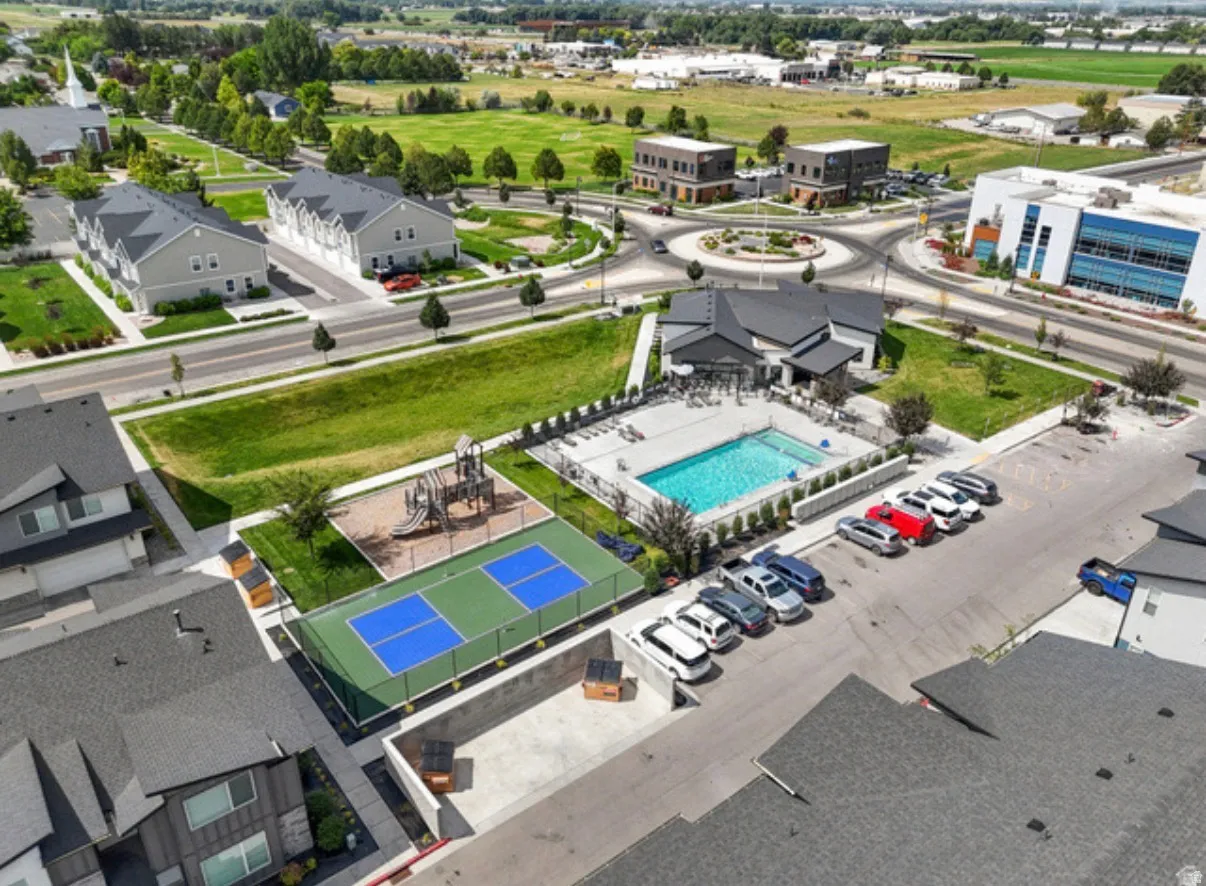 Community amenities featuring a swimming pool, dedicated clubhouse, sports court, and playground area