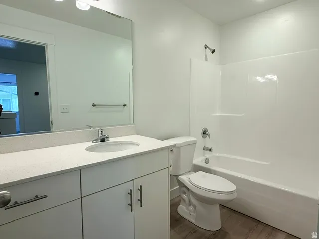 White vanity with ample counter space, integrated sink, and chrome faucet