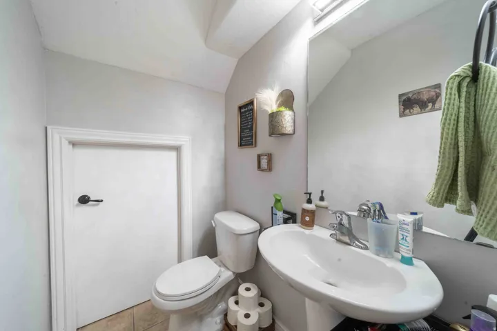 Bright bathroom with dual vanity sink, chrome faucet fixtures, and ample counter space