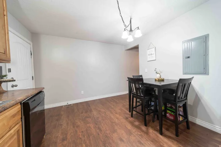 Wood-finish flooring, recessed lighting, and a contemporary chandelier