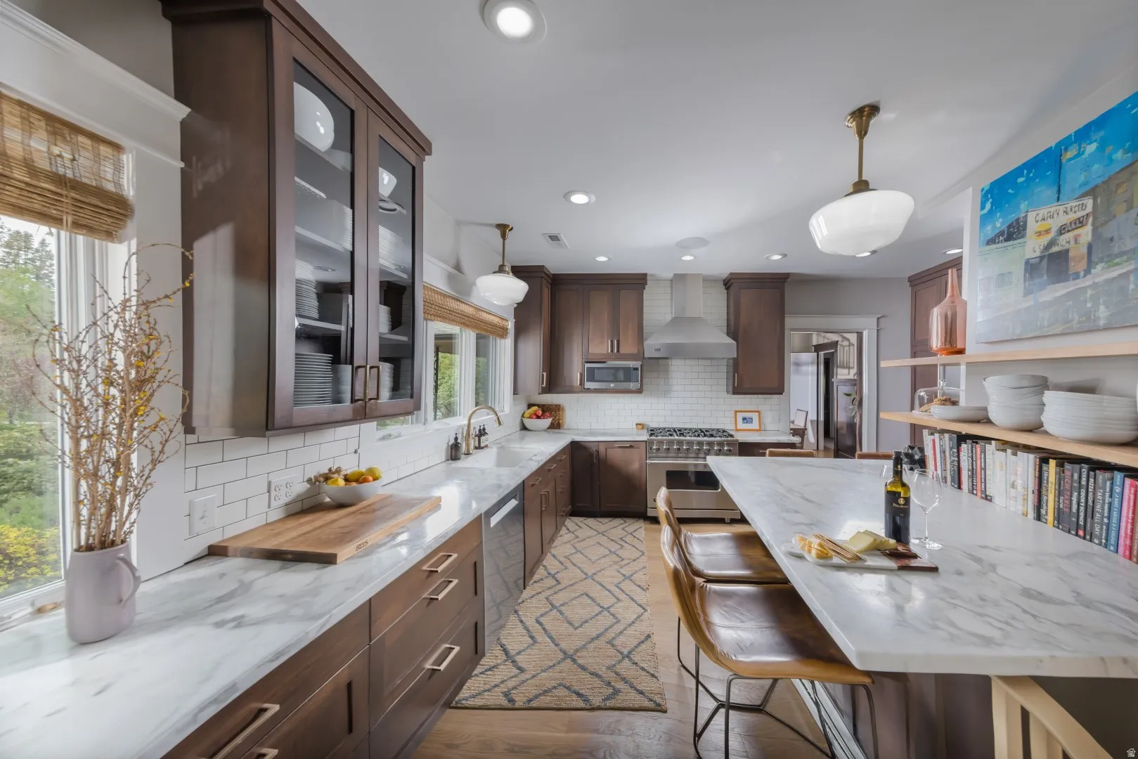 Kitchen featuring wood cabinetry, white subway tile backsplash, and light-toned countertops