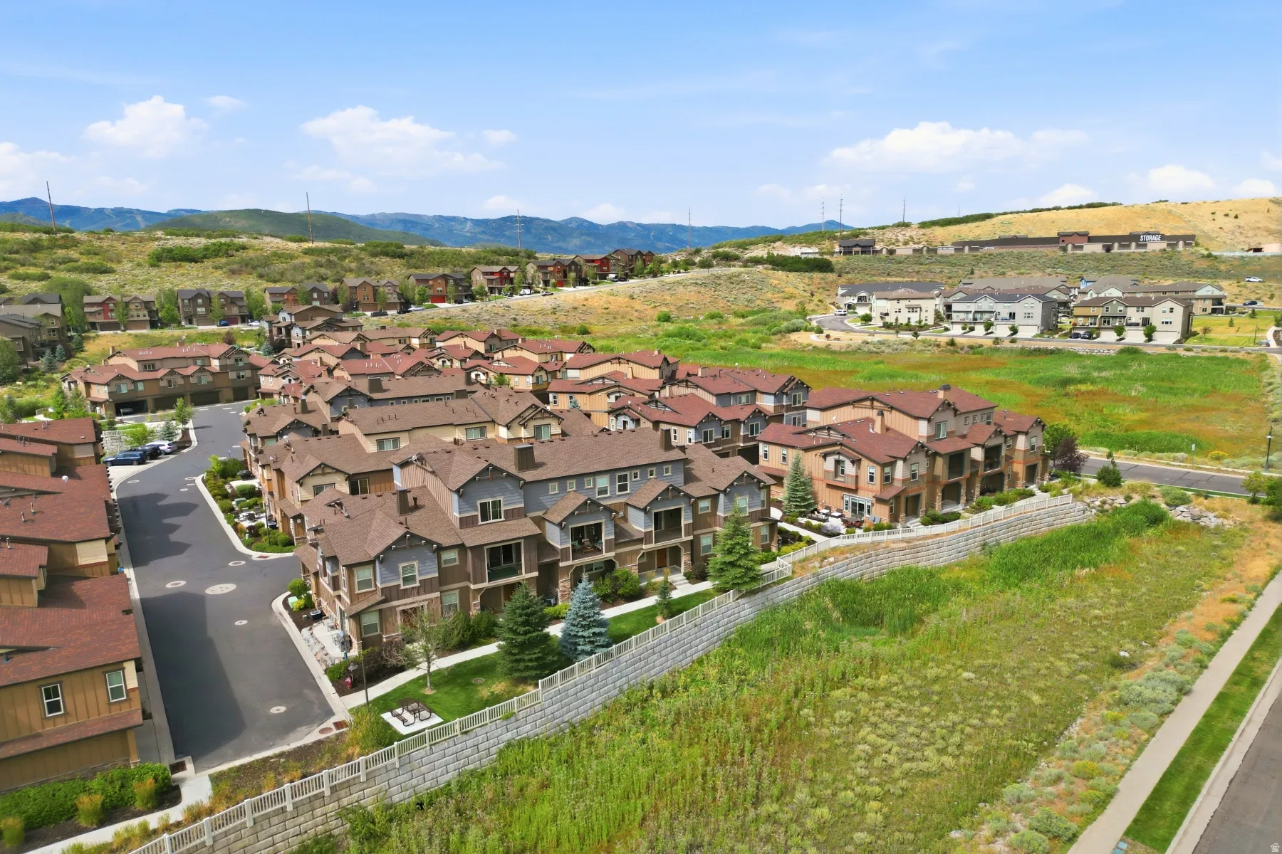 Community of multi-level townhomes with varied exterior finishes and attached garages
