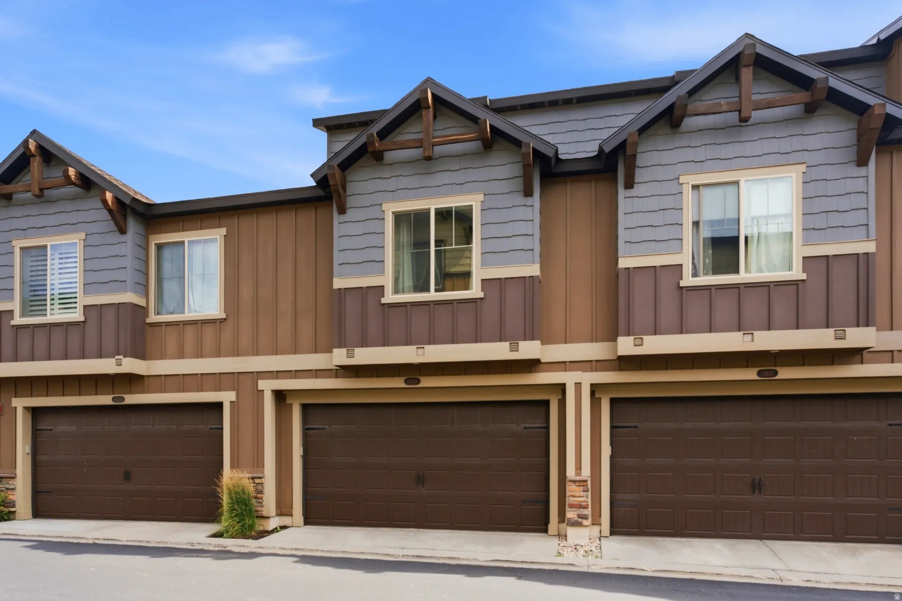 Multi-level exterior featuring horizontal siding, vertical paneling, and shingle accents
