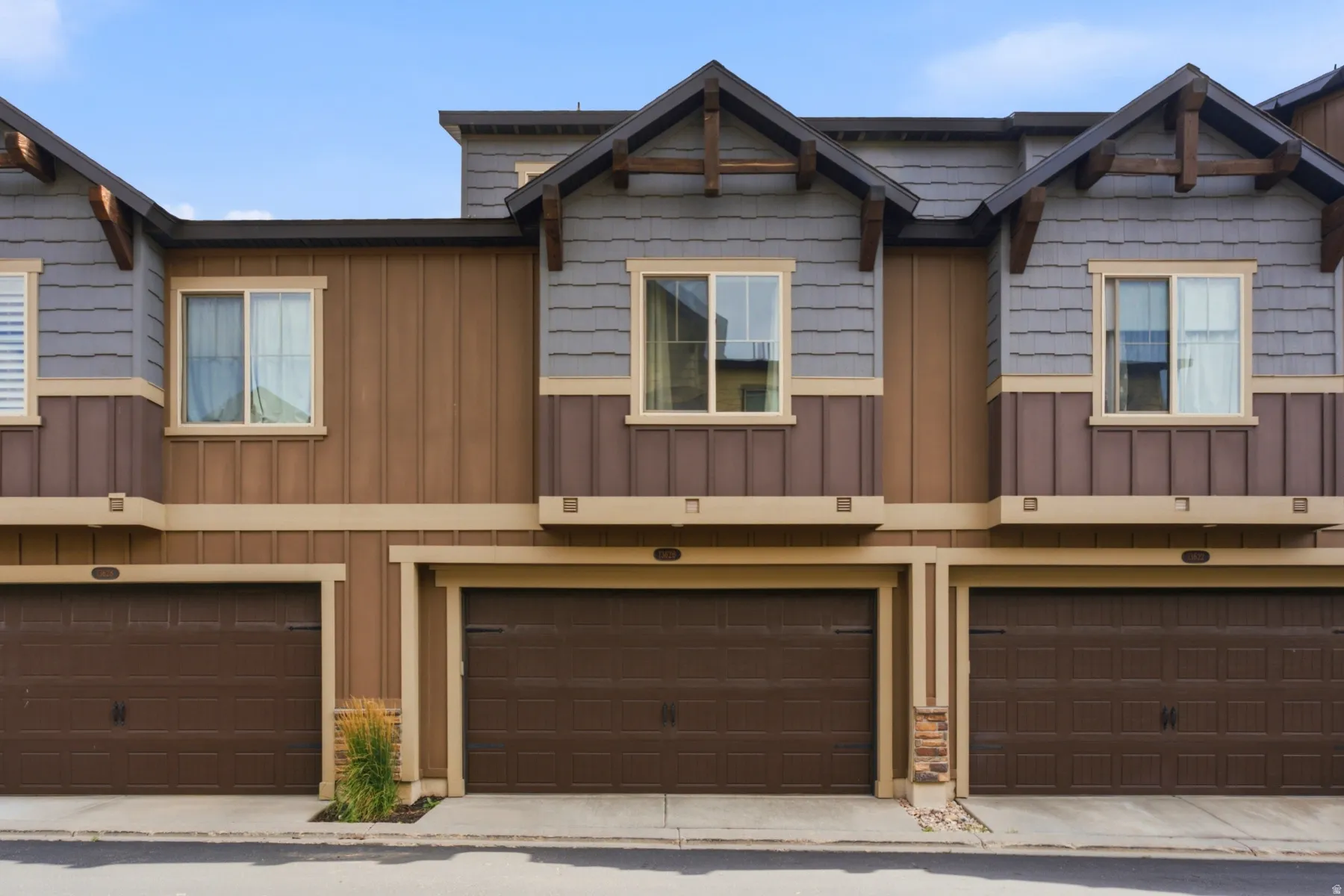 Multi-story exterior with a combination of board and batten siding, horizontal siding, and shingle siding