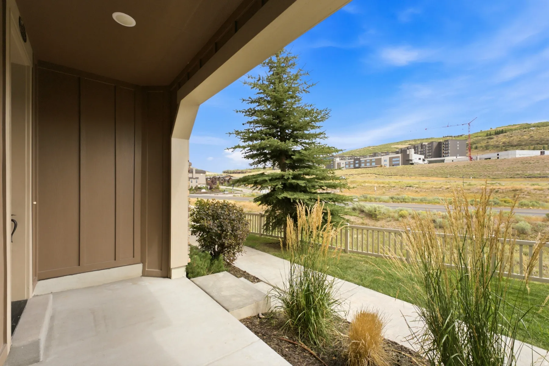 Covered concrete porch with integrated recessed lighting