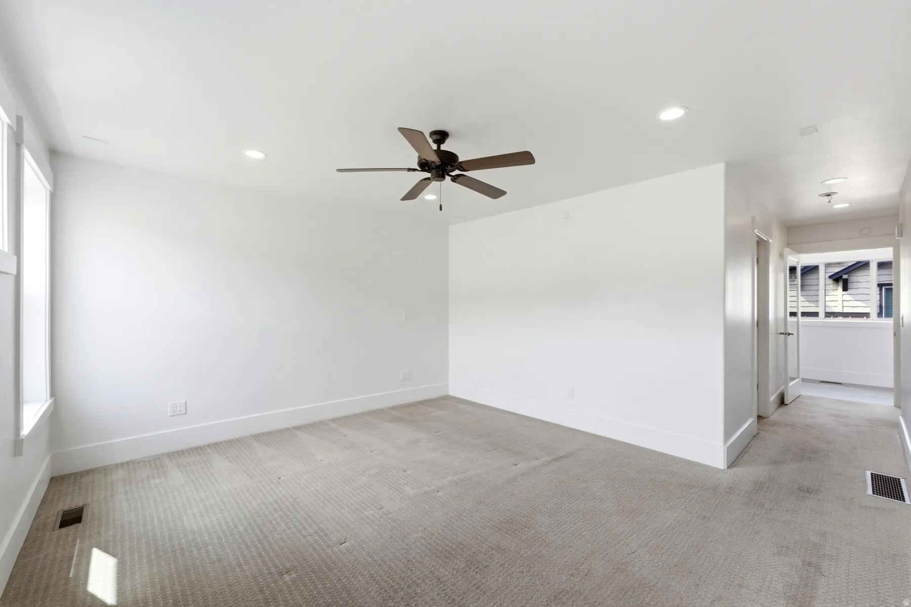 Carpeted room featuring a ceiling fan, recessed lighting, and white trim
