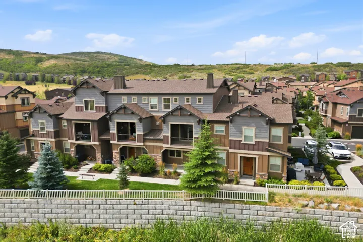 Multi-level townhome exteriors featuring varied siding materials and individual balconies