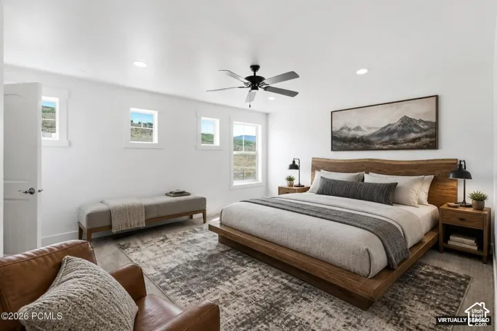 Recessed lighting illuminates the room, complemented by a ceiling fan