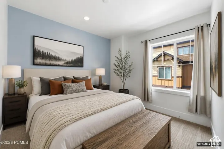 Carpeted flooring, recessed lighting, and a multi-pane window with dark curtain rods