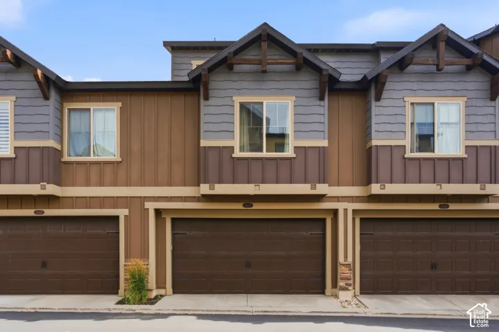 Multi-story exterior with a combination of board and batten siding, horizontal siding, and shingle siding