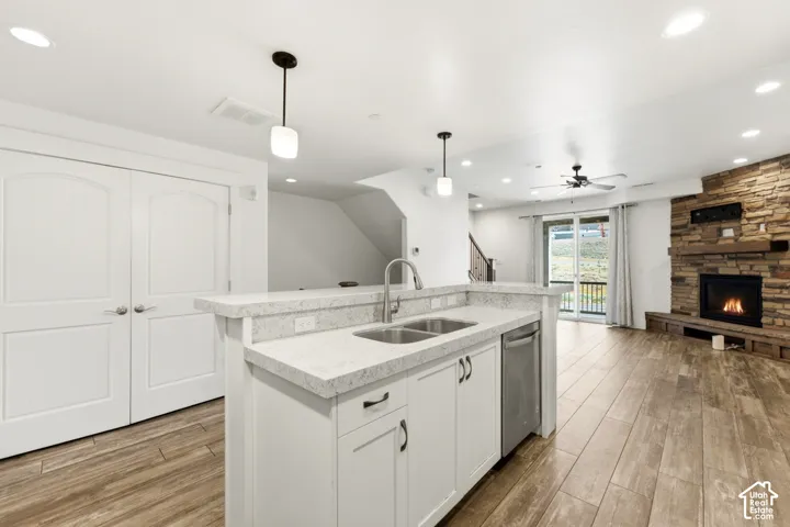 Chef's kitchen featuring a large center island with stainless steel appliances, white cabinetry, and quartz countertops