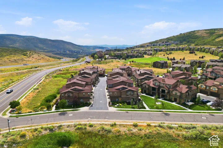 Residential community surrounded by natural landscapes and a paved road
