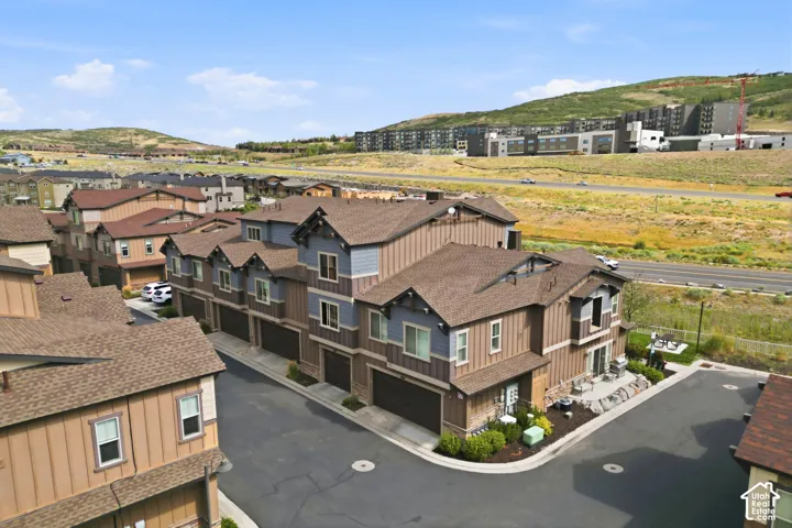Townhome community with multi-level residences, attached garages, and private patios