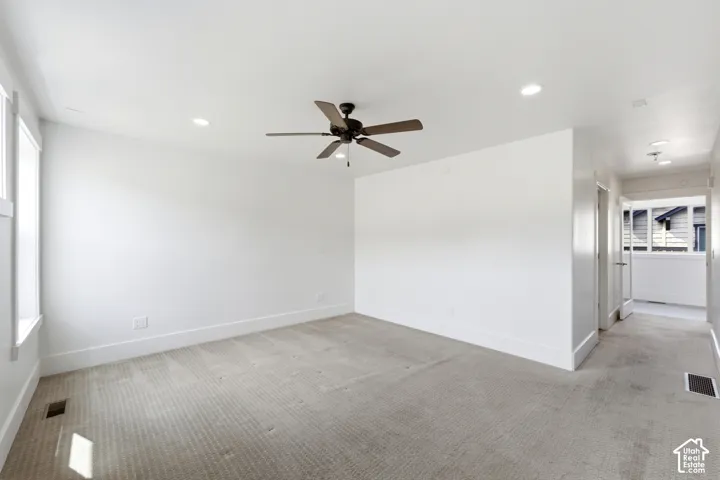 Carpeted room featuring a ceiling fan, recessed lighting, and white trim