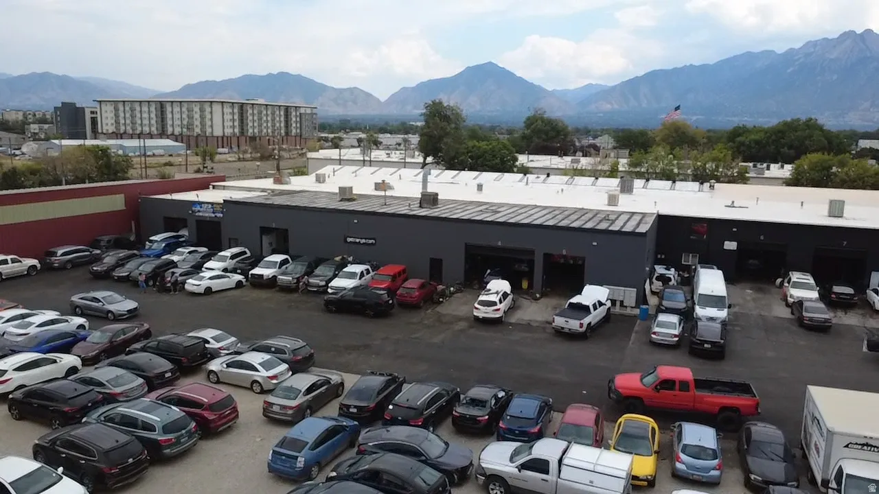 Commercial building with multiple service bays and large paved lot