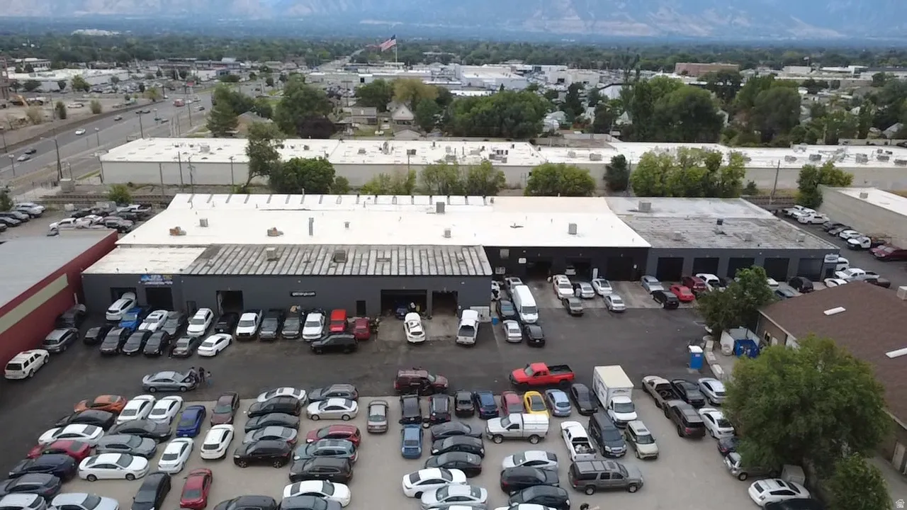 Commercial building with multiple service bays and an expansive asphalt parking area