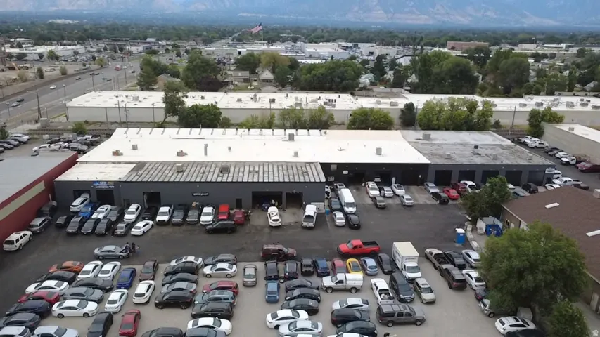 Commercial building with multiple service bays and an expansive asphalt parking area