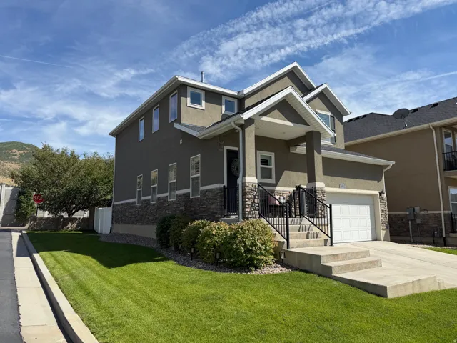 Two-story exterior with stucco finish and stone accents