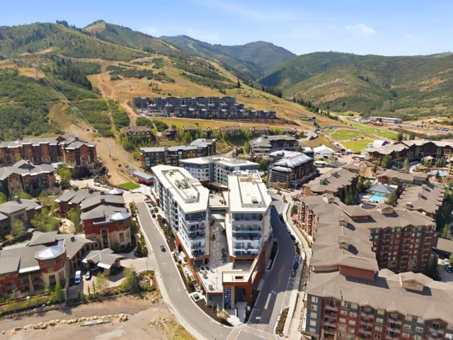 Mountainous landscape featuring residential structures and developed roadways