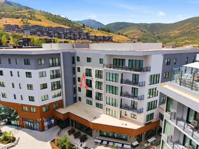 Modern multi-story building featuring balconies with glass railings